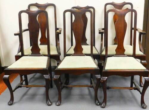 A set of six (4+2) Queen Anne style dining chairs, each with an hour glass splat, drop in seat in later scroll material, on cabriole front legs terminating in pad feet with sabre back legs, the carvers 107cm high. (6)