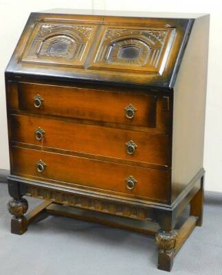 A 20thC oak finish bureau, with panelled fall above three drawers with ring handles and articulated loafers on compressed orb legs terminating in block feet joined by plain H stretcher, 100cm high, 77cm wide, 53cm deep.