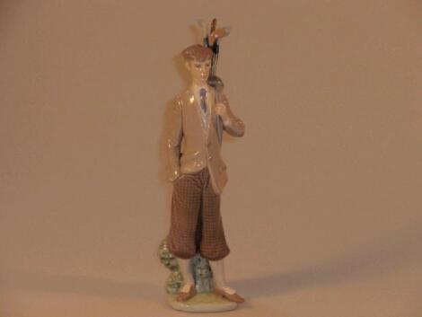 A Lladro figure of a golfer with clubs