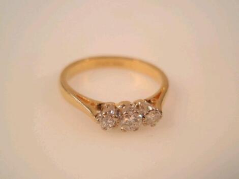 A three stone diamond ring in 18ct gold