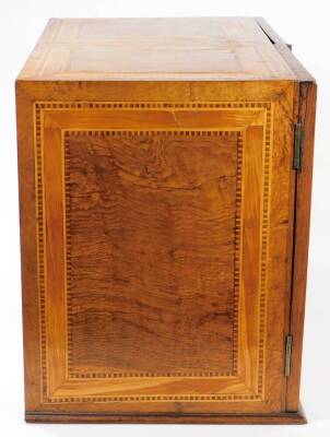 A fine late 16thC South German marquetry table cabinet or kunstkammer, probably Augsburg, with early 19thC alterations, the two doors revealing panels of musical trophies, the central bank of drawers and secret compartments depicting town scenes with bird - 3