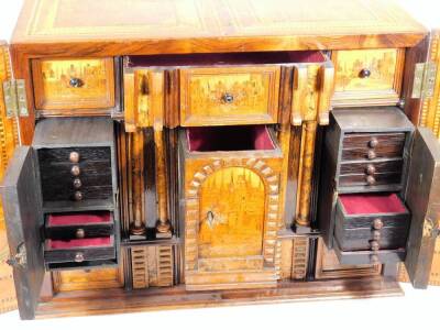 A fine late 16thC South German marquetry table cabinet or kunstkammer, probably Augsburg, with early 19thC alterations, the two doors revealing panels of musical trophies, the central bank of drawers and secret compartments depicting town scenes with bird - 9