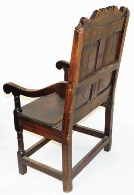 A principally late 17thC oak Wainscot chair, with a scroll cresting rail, raised above two panels of flowers, with scroll arms on turned supports, the plain seat raised turned on turned legs, terminating in block feet, joined by block stretchers, with lat - 3