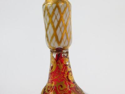 A pair of late 19thC Bohemian flashed cranberry glass vases, of ogee form, raised on a slender collared stem, reserve painted with flowers, against a white ground, with gilt foliate decoration against the cranberry glass, 26.5cm H. (AF) - 4