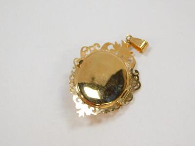 A 9ct gold amethyst and diamond locket pendant, of oval form with a central star burst, within an open work foliate border, 5.6g. - 2