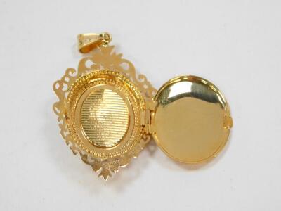 A 9ct gold amethyst and diamond locket pendant, of oval form with a central star burst, within an open work foliate border, 5.6g. - 3