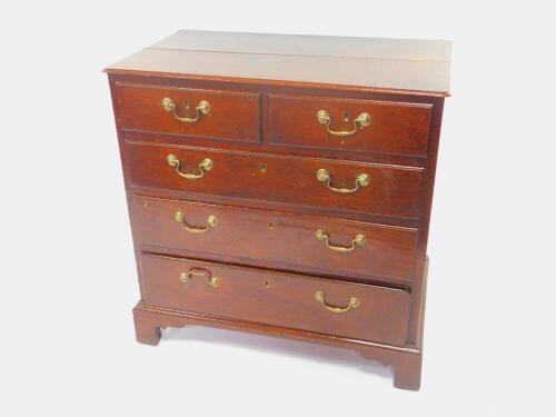 A George II oak chest, of two short over three long drawers, raised on bracket feet, 88cm High, 86cm Wide, 51cm Deep.