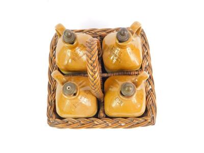 A set of four Victorian stoneware two tone spirit jars, in a four division wicker basket, comprising Scotch Whisky, Brandy, Gin, and Irish Whiskey, registration lozenge for 5th October 1877. - 2