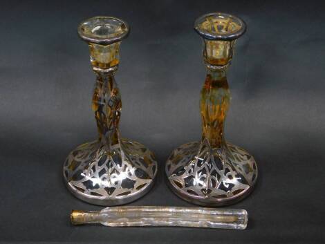 A pair of early 20thC glass candlesticks, with silver resist decoration, 19cm H, together with a Georgian glass scent bottle with gilt decoration, worn, 19cm W. (3)