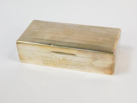 A George V Lincolnshire Regiment silver cigarette box, of rectangular twin division form, the hinged lid bearing the crest and banner of The Lincolnshire Regiment, box engraved "Presented to Lieut; H R Greenwood, by The Officers of The Forth Battn. The Li