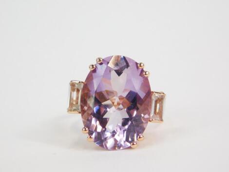 A silver gilt Rose de France amethyst and white topaz Rose Midas ring, the high claw set oval cut amethyst, 16ct, flanked by two baguette cut topaz, 3.12ct, size N/O, with certificate.