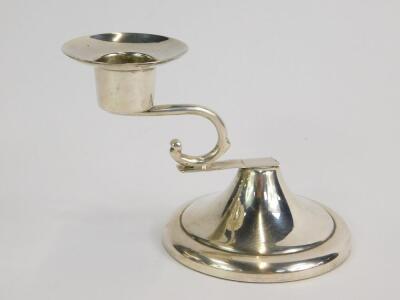 A Mexican loaded silver candlestick, with a scrolling arm, raised on an outswept circular base, stamped sterling, 8.5cm H, 4.66oz.