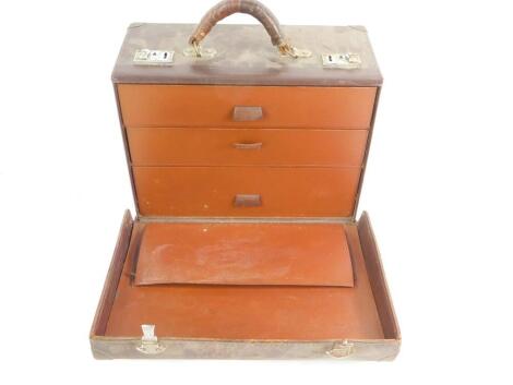 A veterinary surgeon's early 20thC leather three drawer chest case, containing medical equipment, bandages and drug jars, one set of phials named to Dr G W Sturgess, case 18cm H, 38cm W, 28cm D.