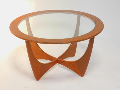 A G-Plan 1960's circular teak occasional table designed by Victor Wilkins, inset glass, raised on an 'X' frame, 83.5cm diameter, 45cm high.