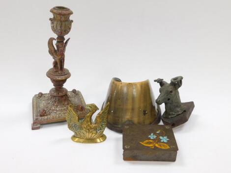 A French Empire patenated brass candlestick, cast to the stem with a sphinx, 20cm H, together with a horse's hoof, brass desk match striker cast as a phoenix rising from the flames, 7cm W, a Jungendstil copper stamp box, enamel decorated to the lid with f