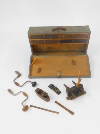 A carpenter's tool chest, containing moulding planes, Millers Falls No 75 plane, braces, and small tools, 21cm H, 78.5cm W, 43cm D.