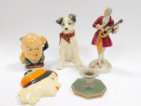 An Art Deco pottery figural wall plaque, possibly Cope, bust of a girl in an orange, green and black stripped bobble hat, Burleigh Ware character jug modelled as Churchill 'Victory', Russian porcelain figure of a terrier, Copenhagen Fajence chamber stick,