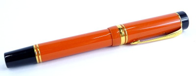 A Parker red and black two tone Duofold fountain pen, with gold plated mounts, the nib stamped 18K 750.