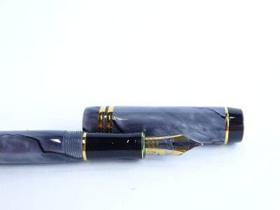 A Parker Duofold grey simulated marble and black fountain pen, with gold plated mounts, the nib stamped 18K 750. - 2