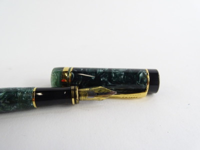 A Parker Duofold fountain pen, with green simulated marble effect and black, silver plated bands, the nib stamped 18K 750. - 2