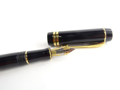 A Parker Duofold fountain pen in black, with gold plated bands, the nib stamped 18K 750. - 2