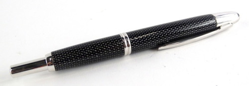 A Pilot carbon fibre and plated fountain pen, with retractable nib in black and silver.