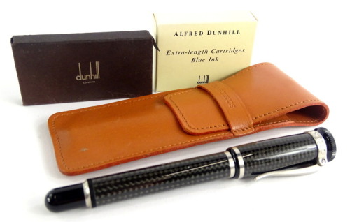 An Alfred Dunhill grey carbon fibre fountain pen, with brushed metal mounts signed to the hinged clip, and two packs of Dunhill ink cartridges, possibly incomplete, and a papyrus leather case.