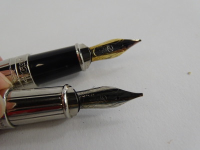 An S.T. Dupont plated fountain pen, with blackened end, the nib stamped 18k 750, and an extra nib, etc. (2). - 2