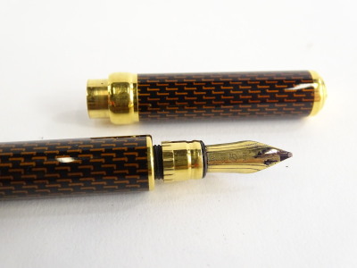 An S. T. Dupont fountain pen, with gold plated mounts, decorated in gold and black enamel style titled Laque de Chine, the nib stamped 18k 750. - 2