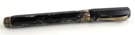 A Montegrappa simulated grey and black marble fountain pen, with silvered coloured clip, maker's name engraved to the broad collar, the nib stamped 750 and with gilt Greek key embellishment.