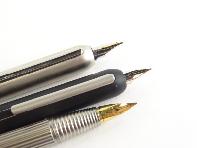 Three Lamy matt metal bullet shaped fountain pens, one with ribbed body, one in black, the other silvered. - 2