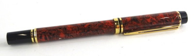 A Waterman black and brown marbled fountain pen, with gold plated mounts, the nib stamped 750 Ideal Paris.