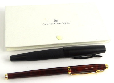 A Faber-Castell black and metal blackened steel fountain pen, with engine turned grip, and an Elysee fountain pen, etc. (2)