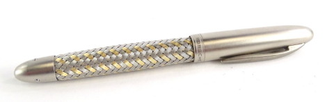 A Porsche Design Tec Flex steel and gold fountain pen, with part woven decoration, the nib stamped 750 M 18k.