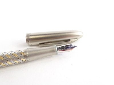 A Porsche Design Tec Flex steel and gold fountain pen, with part woven decoration, the nib stamped 750 M 18k. - 2