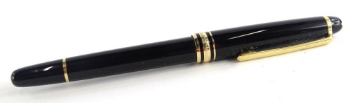 A Montblanc Meisterstuck black and gilt fountain pen, the nib stamped 14k 585.