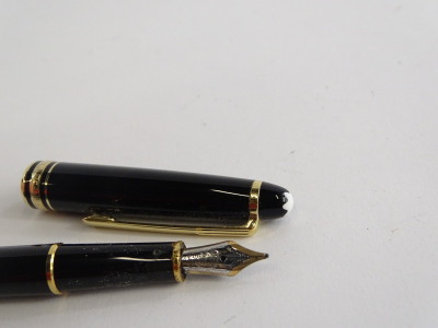 A Montblanc Meisterstuck black and gilt fountain pen, the nib stamped 14k 585. - 2