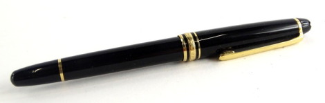 A Montblanc Meisterstuck black and gilt fountain pen, the nib stamped 14k 585.