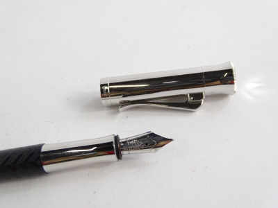 A Graf Von Faber-Castell black and silvered fountain pen, with feathered decoration, the nib stamped 18ct 750. - 2