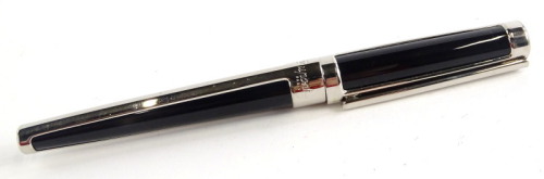 A St Dupont black and silvered fountain pen, the nib engraved with the company emblem.