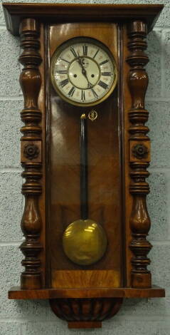 A late 19th/early 20thC Vienna wall clock, the walnut case decorated with split turning, with a gadrooned base, lacking top, 94cm high.