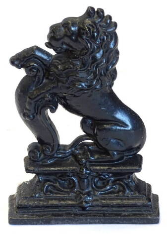 A cast iron door stop, modelled in the form of a heraldic lion, on a rectangular base, 38cm high.