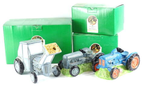 Two Border Fine Arts James Herriott's Country Kitchen novelty money boxes, each modelled in the form of a tractor, titled Fordson Major Money Bank (A0591) and Fergie Money Box (754056) and a similar country kitchen novelty teapot, all boxed (3).