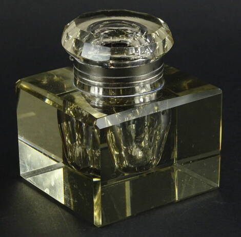 A large square Edwardian faceted glass inkwell, with silver plated mounts, 10cm wide.