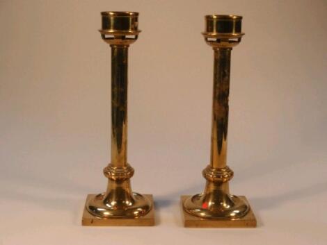 A pair of late 19thC brass ecclesiastical candlesticks with fixed sconces