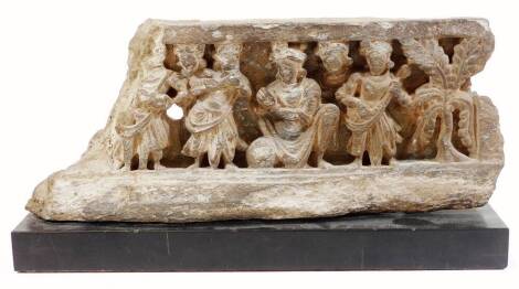 A Gandhara 2nd Century carving, formed as figures aside tree, on an ebonised plinth base, labelled, 19cm H.