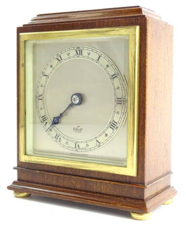 An Elliott mantel timepiece, with silvered dial and chapter ring, stamped French escapement, bevel glass, the mahogany case mounted on bun feet, numbered to underside 2198, CJ, 9 62, 15cm high, 13cm wide.