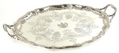 A Victorian Elkington & Co oval two handled tray, with engraved and cast decoration in neo classical Adam revival style, the large shaped cartouche engraved centrally with a crest, involving an armour helmet, tower and two swords, makers stamp to undersid