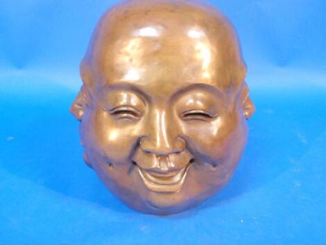 A cast bronze head of a Buddha