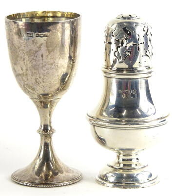 A George V silver sugar castor, with pierced top, baluster base and domed foot, London 1910, and a small silver goblet, Sheffield 1922, 7oz (2).